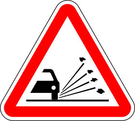 Traffic sign of Portugal: Warning for loose chippings on the road surface